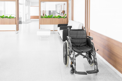empty wheelchair parked in hospital hallway