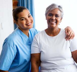 smiling caregiver and senior woman