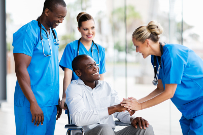 happy female doctor greeting disabled patient in hospital